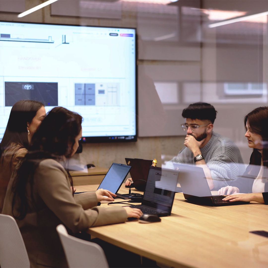 Collaborative innovation at TRISON workplace, team working together on projects.