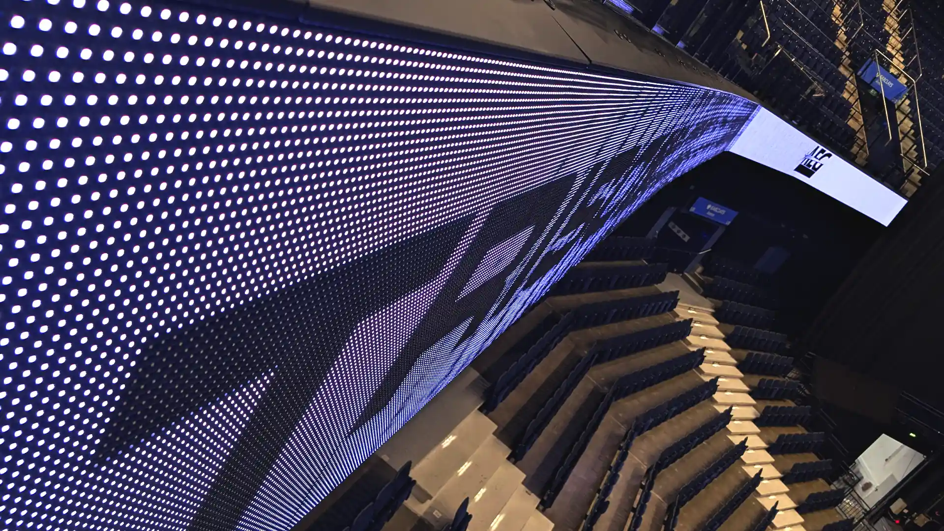 Continuous LED ring spanning the upper seating tier of Barclays Arena.