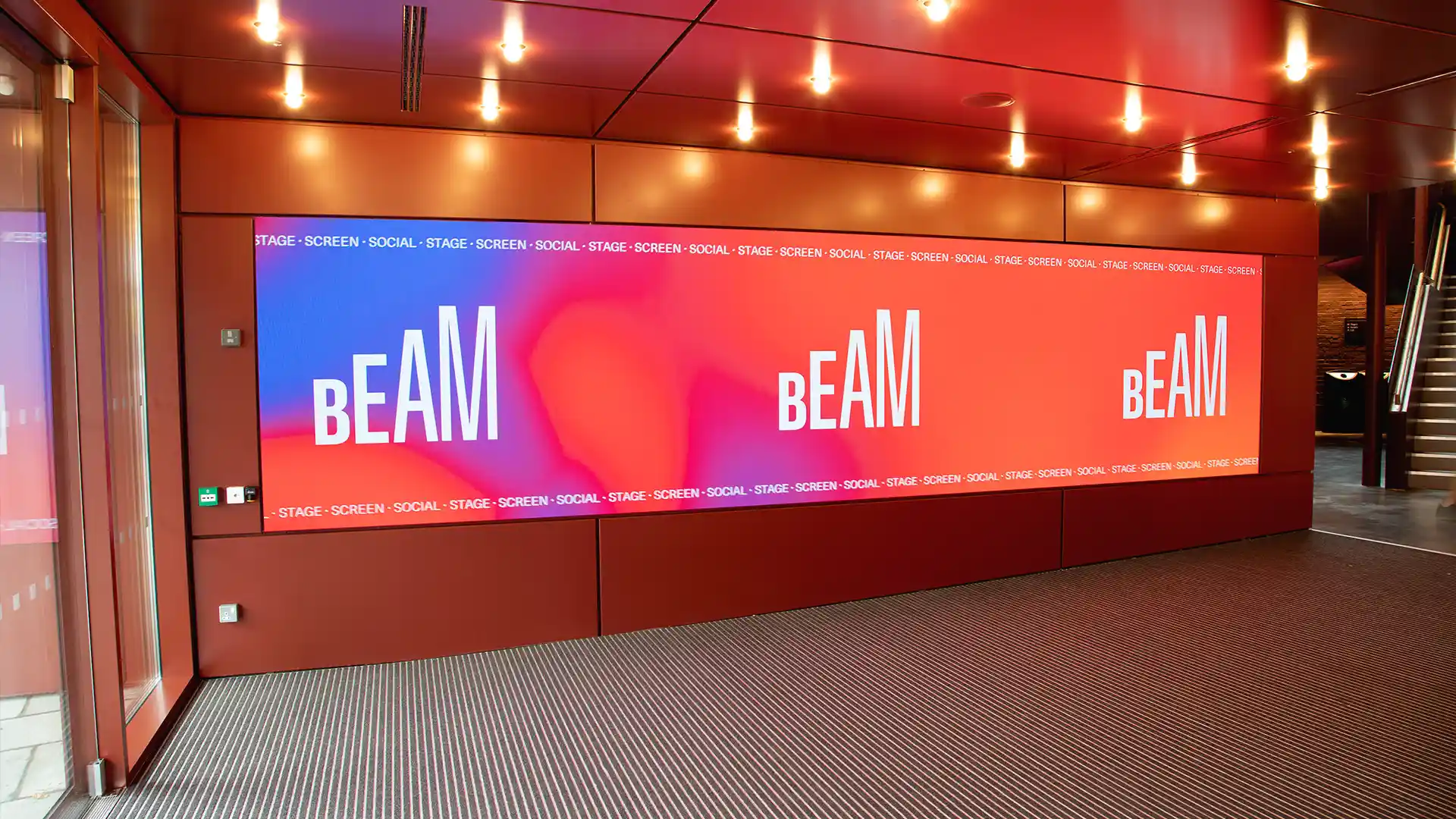 Large LED screen at BEAM Theatre reacting to visitor gestures with interactive content.
