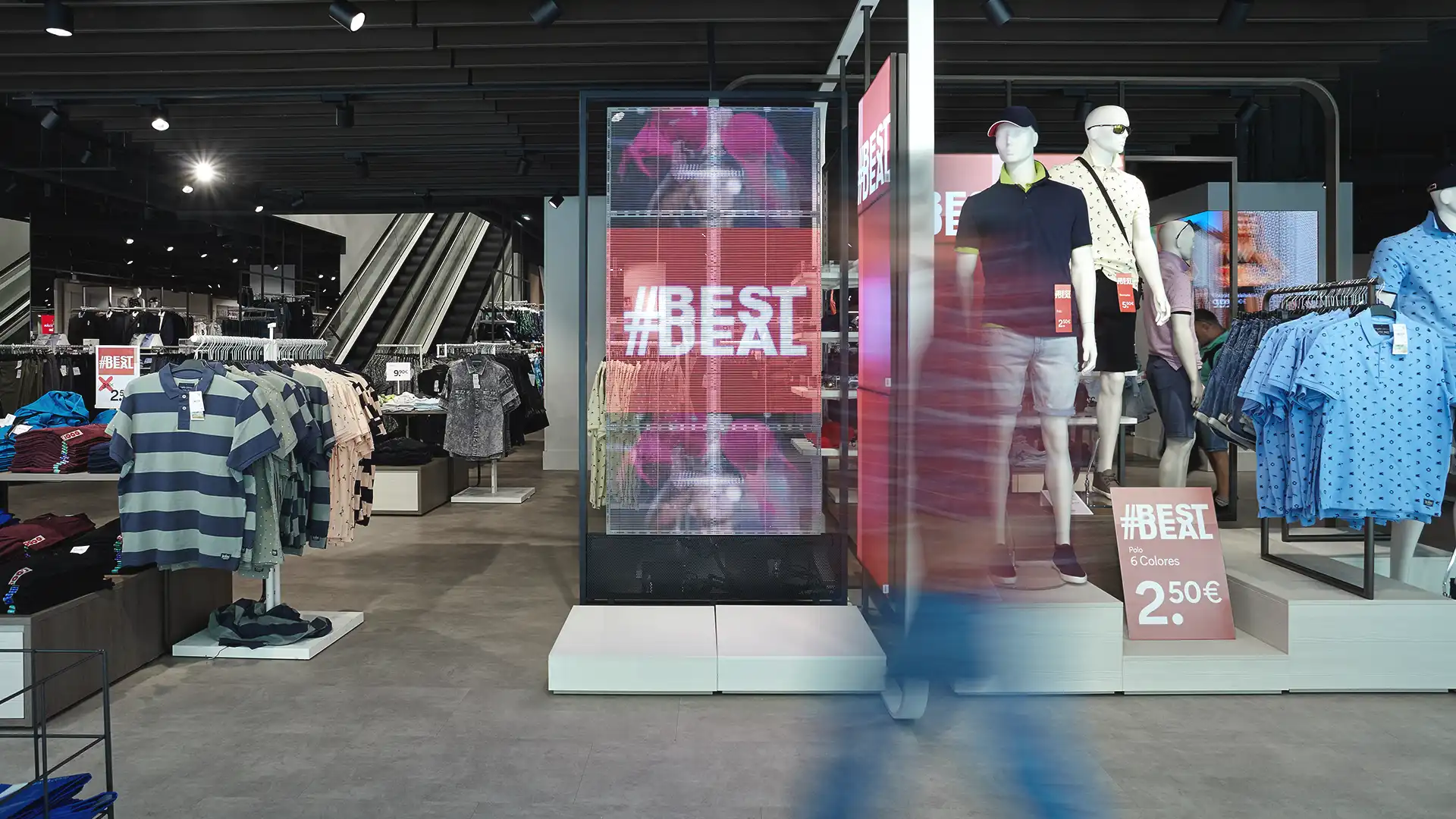 Interior of C&A store with synchronized digital displays ensuring unified visual communication.