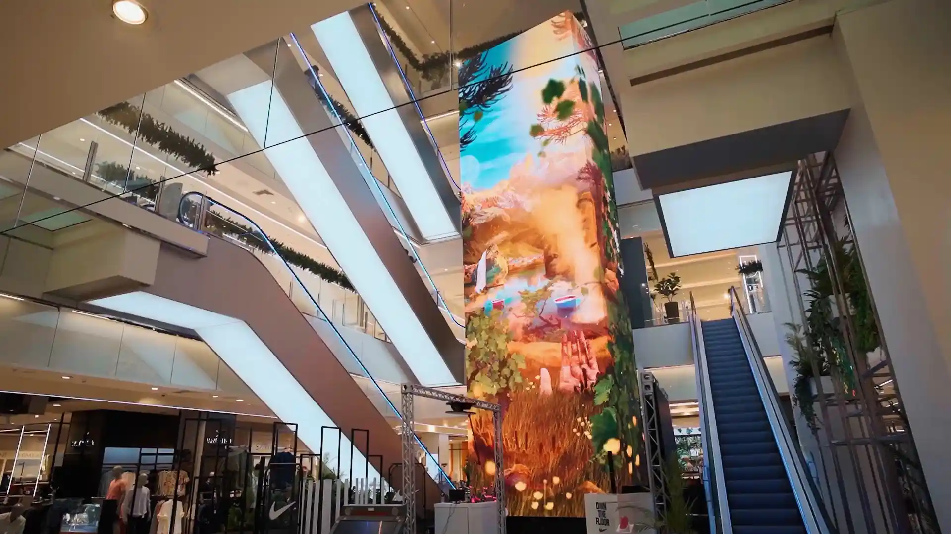 Visitors interacting with immersive AR and visual effects around the Falabella digital totem.