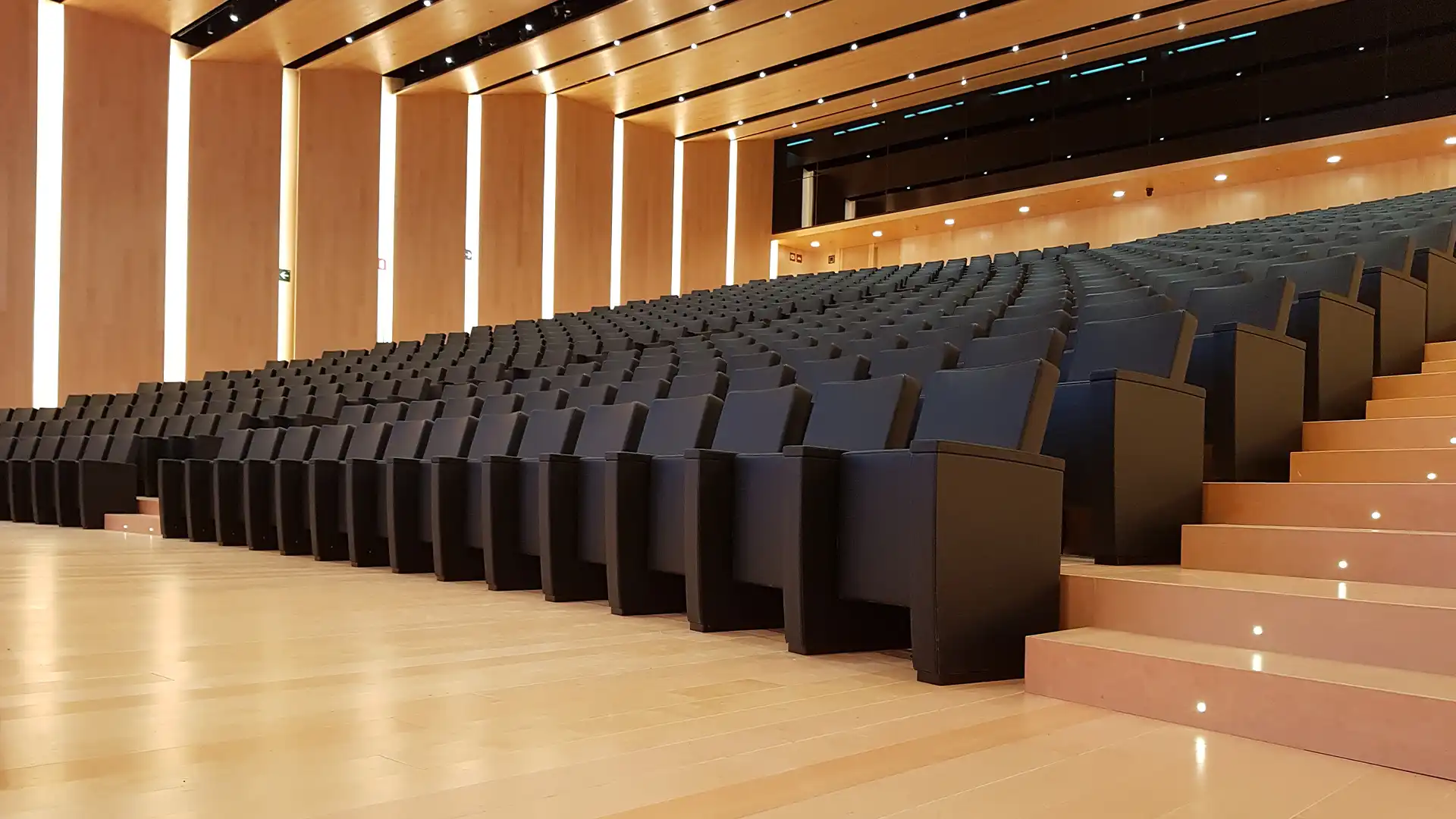 Large LED screen setup in the Inditex HQ auditorium with professional lighting and stage integration.