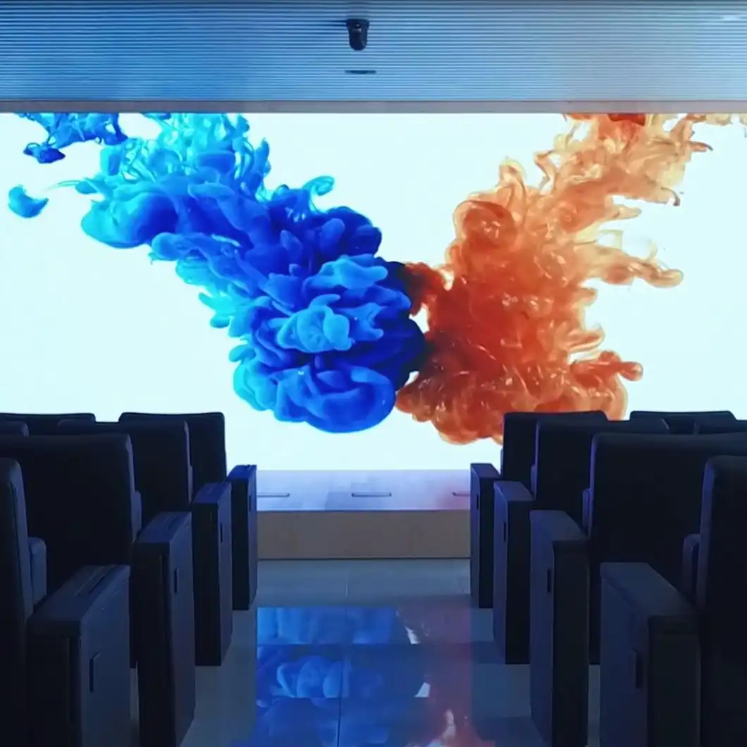 Press room with large LED display, microphones, and translation booths.