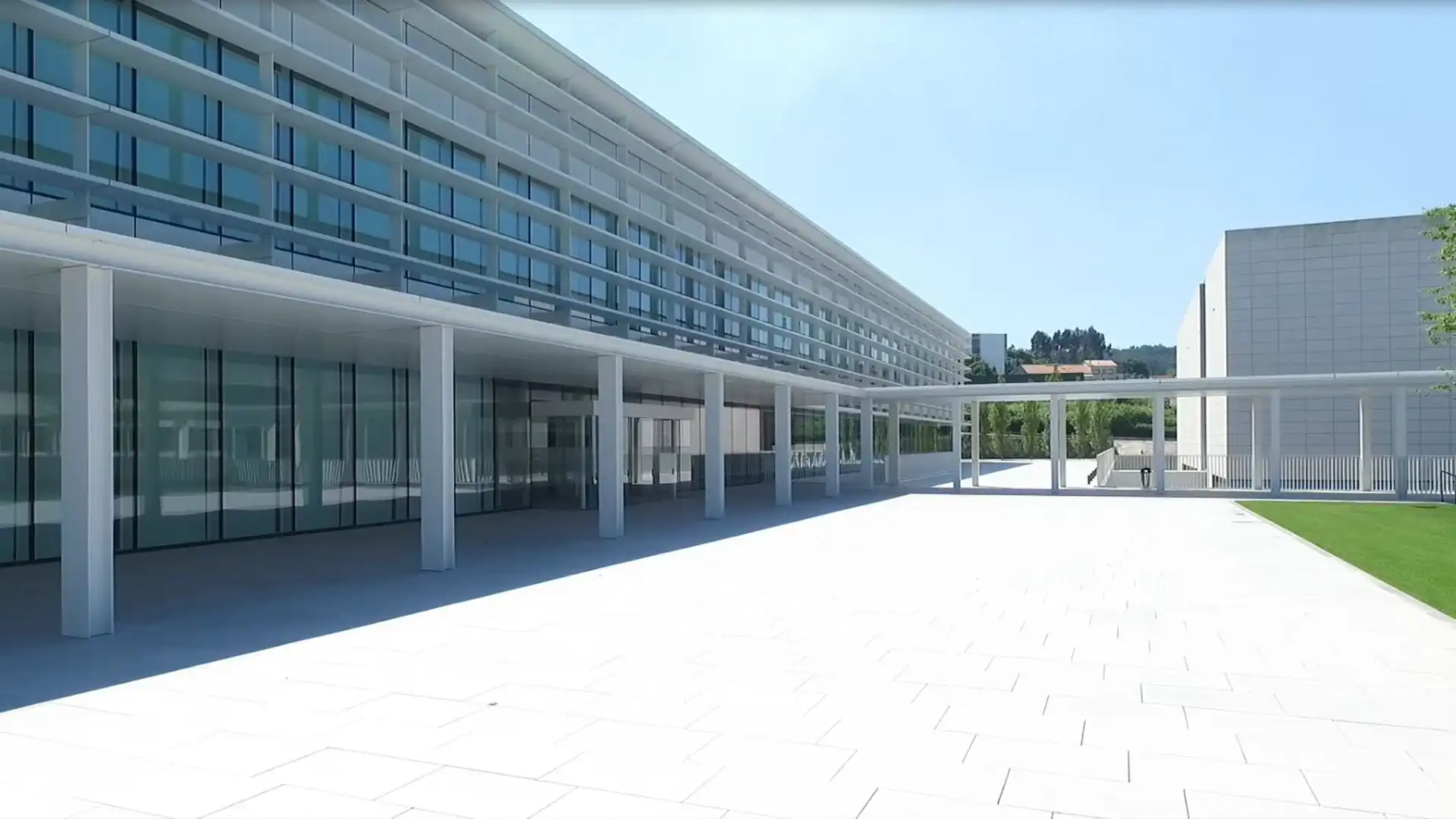 People working in Inditex HQ open workspace surrounded by digital displays and architectural lighting.
