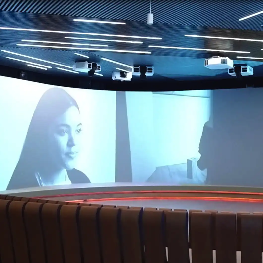 Immersive creativity room with curved projection surfaces and ambient lighting.