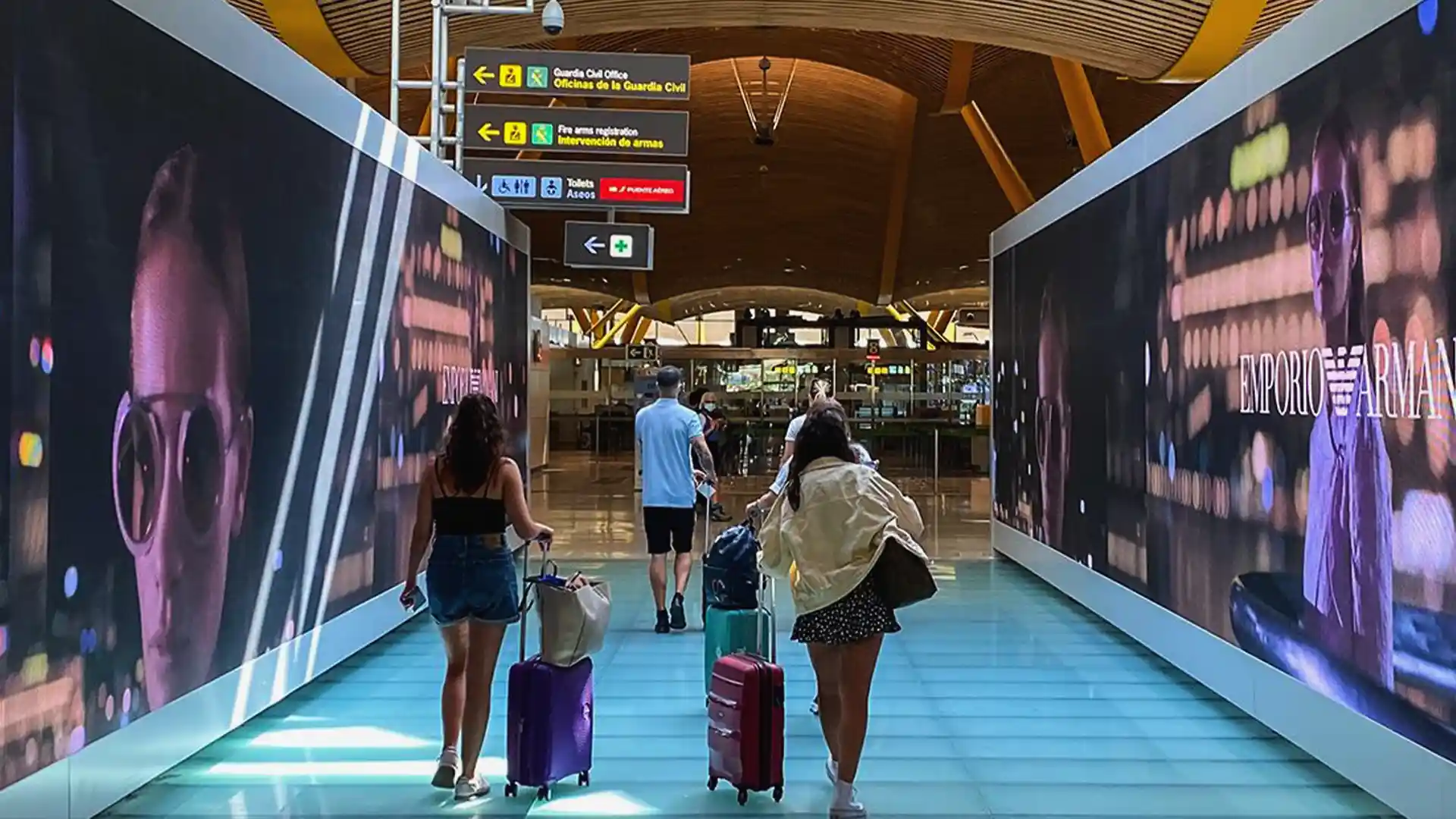 LED screens along airport walkways creating an immersive visual corridor for passengers