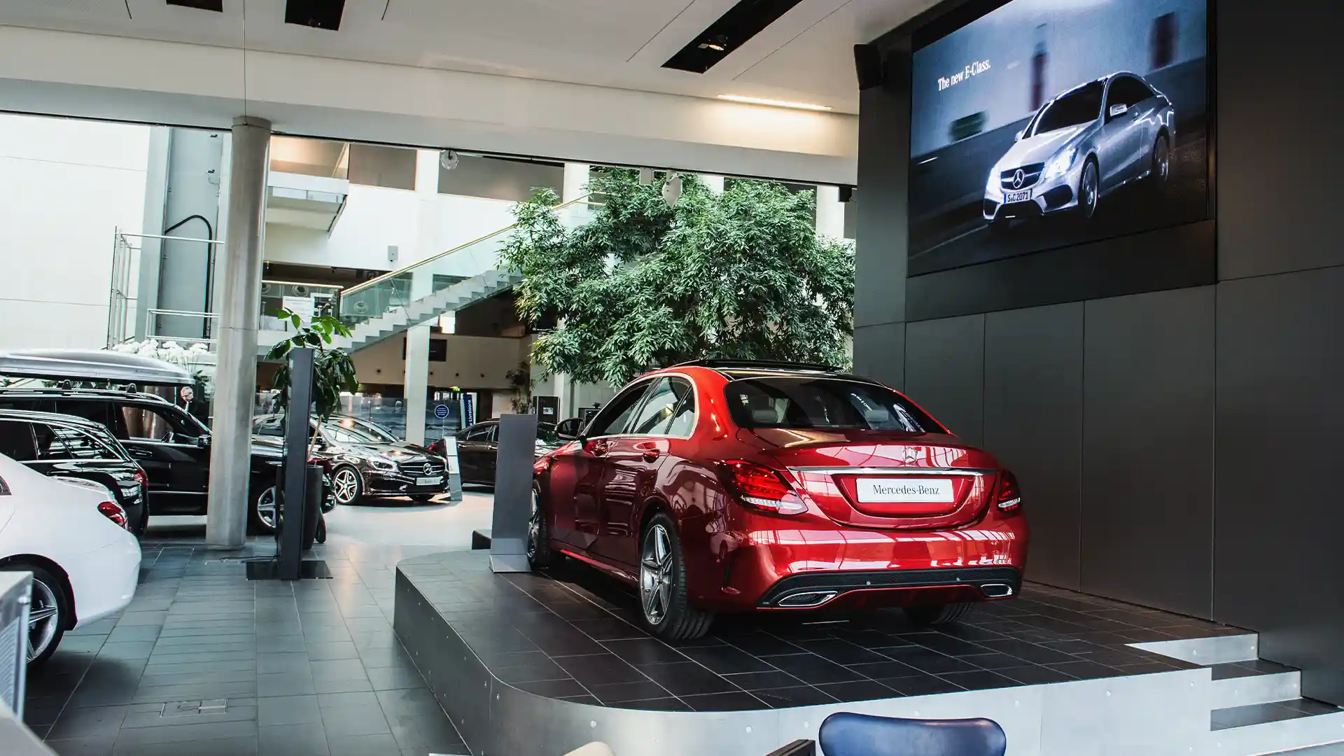 Large Mercedes-Benz Paris LED screen visible from outside, reinforcing premium digital experience by TRISON.