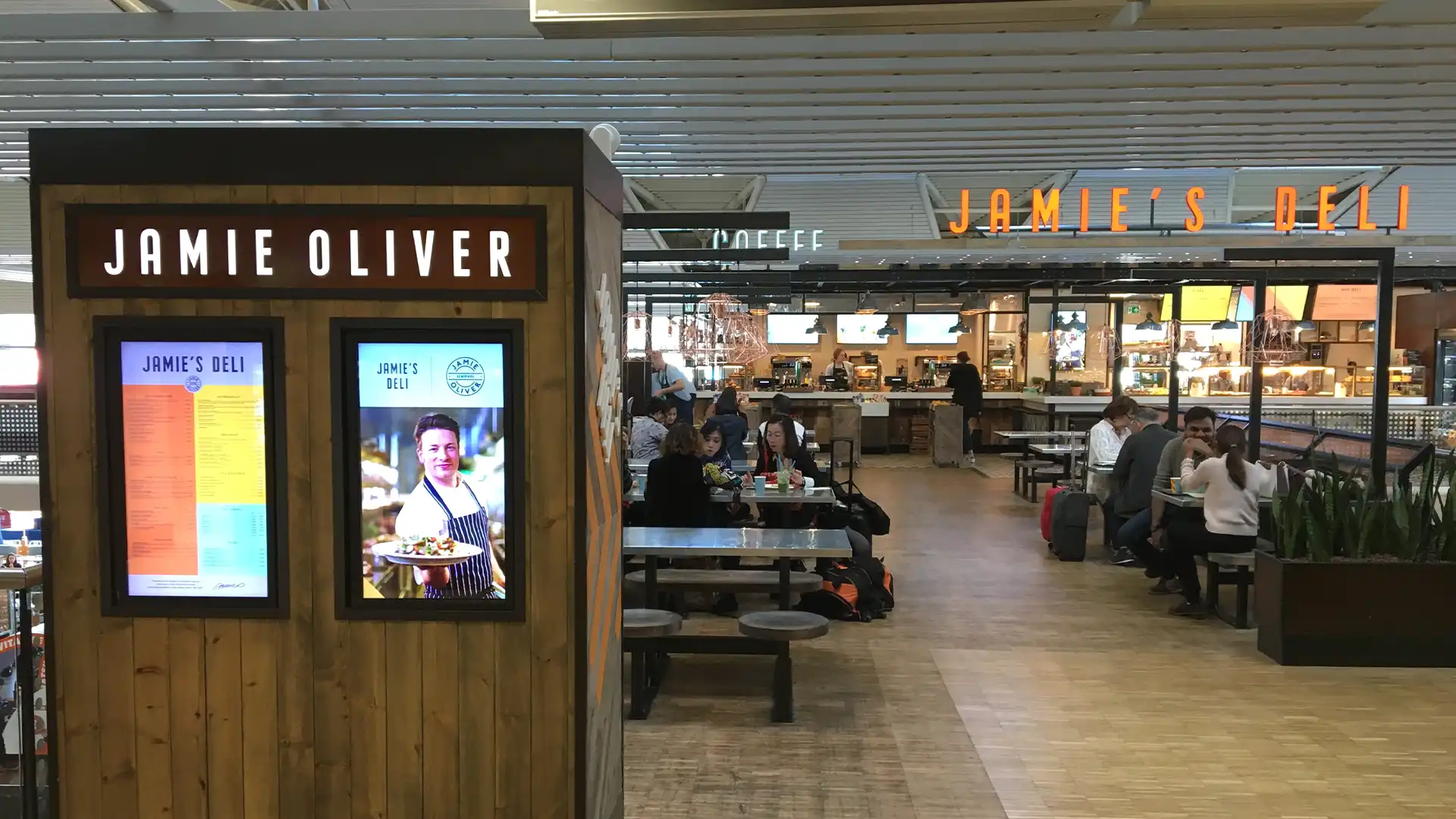 Passenger using an interactive ordering kiosk integrated by TRISON UK at The Mezz in Dublin Airport Terminal 2.