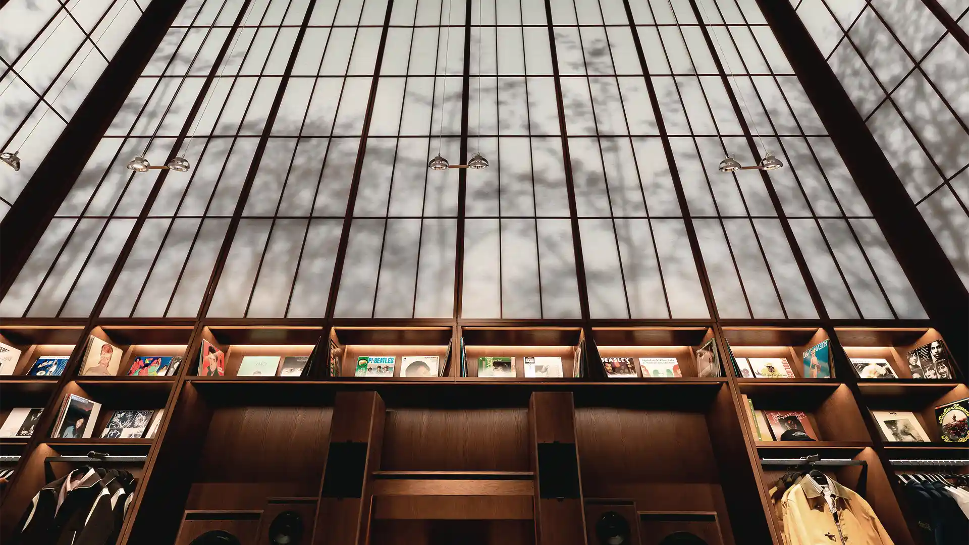 Large-format screen behind Japanese-style panel creating a diffused light effect in Zara Man Osaka